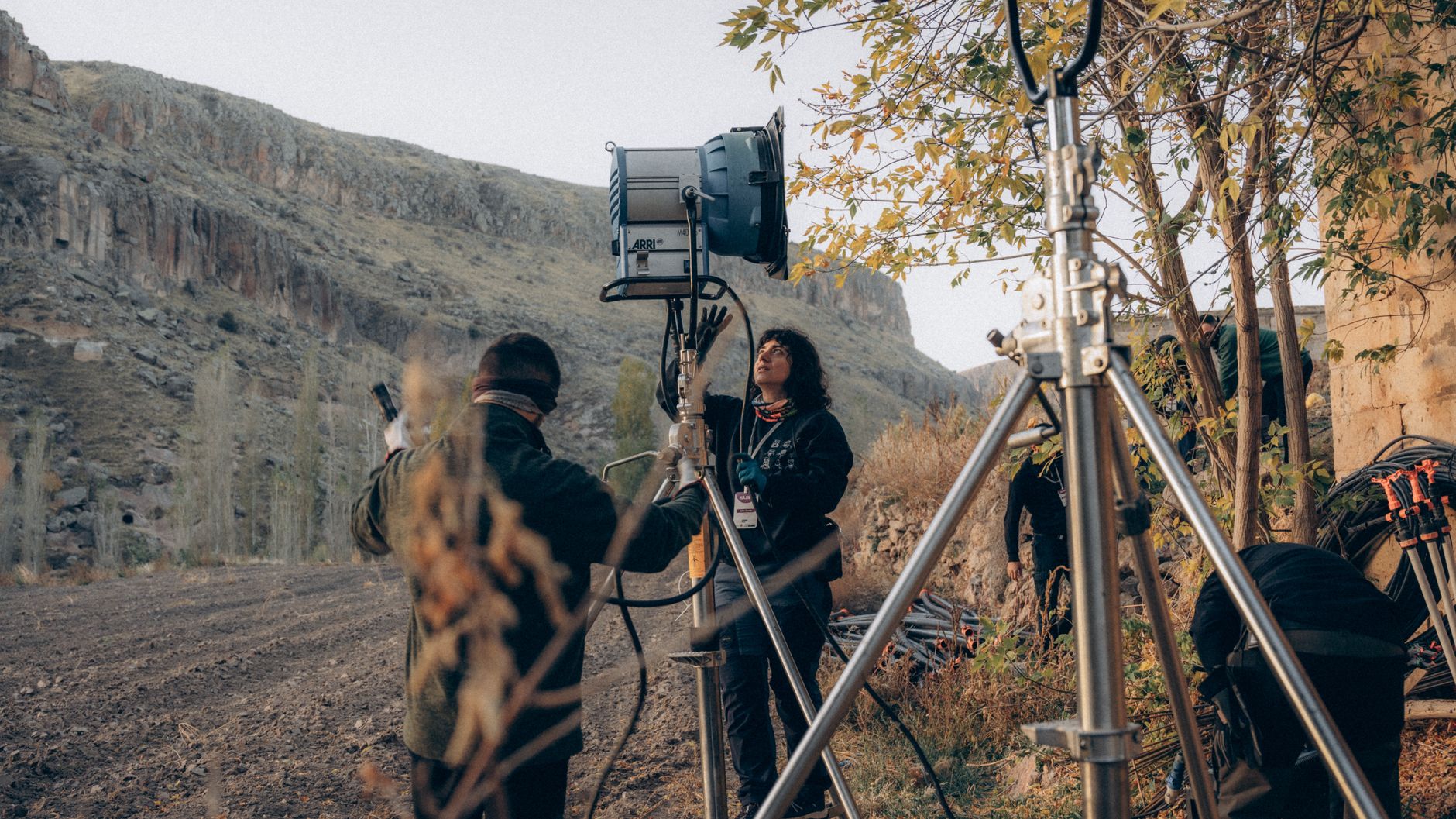 Cinematic video production crew operating camera and lighting rigs